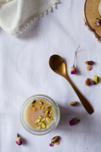 Rose panacotta pot with litchi purée and shredded pistachios from above